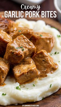 A wooden plate has mashed potatoes, and garlic pork bites on it. Pork Tenderloin Cubes Recipes, Pork Loin Cubes Recipes, Creamy Garlic Pork Bites, Pork Chop Bites Crock Pot, Pork Chops From Pork Loin, Pork Chunk Recipes, Pork Chop Pieces Recipes, Pork Chop And Sausage Recipes, Recipes With Cubed Pork