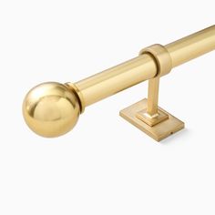 a gold door handle with a ball on the end and a metal rod attached to it