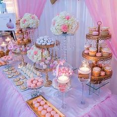 a table topped with lots of cupcakes and cakes