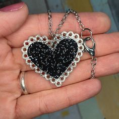 "Embrace a bit of Darkness in your Lovely Heart when you wear this cute Black Heart Glitter Lace Doily Valentines Day Statement Necklace! 🖤 Fun 2 layered pendant is made of laser cut Black Glitter Infused Acrylic and Silver Glitter Infused Acrylic! 🖤 Big and eye-catching, this Sparkly Black Heart Doily Statement Necklace measures 1.5\" from side to side and comes on a 24\" long silver color chain with large lobster clasp! 🖤 This Eye-Catching Black and Silver Valentines Day Necklace is a great Cute Party Jewelry With Heart Charm, Cute Heart Charm Jewelry For Parties, Cute Heart Charm Party Jewelry, Heart Shaped Sparkling Jewelry Gift, Sparkling Heart-shaped Jewelry Gift, Cute Heart Necklace For Party, Cute Heart Necklace For Parties, Cute Heart Necklace For Valentine's Day Party, Mother's Day Heart Pendant Necklace For Party