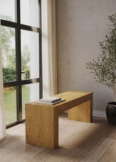 a wooden bench sitting in front of a window next to a vase with a plant