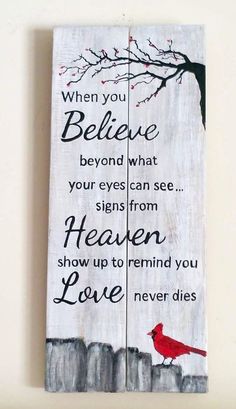 a wooden sign with a red bird on it and the words when you believe beyond what your eyes can see, signs from heaven show up to remind you love