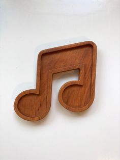 a wooden musical note on a white wall