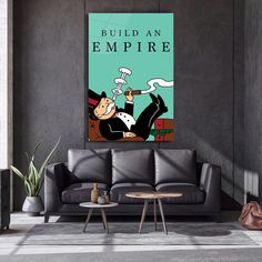 a living room with a couch, coffee table and poster on the wall that says build an empire