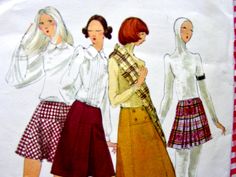 three women in skirts and shirts are standing next to each other on a red and white checkered tablecloth