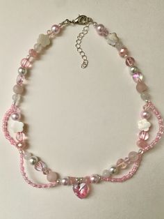 Pink Swirl Necklace -ˋˏ ༻❁༺ ˎˊ-✩ This necklace is dainty and cute, perfect for Valentines day! (MADE TO ORDER)✩ Materials: Beading wire, shell beads, plastic pearls, seed beads, rondelle beads, rose quartz and various other beads. Closed with a lobster clasp.✩ Length: 40cm with a 2in extension, making it a choker fit. It may fit differently depending on the person. If you'd like a longer extension chain, let me know in the special notes at checkout! Pink Pearl Beaded Necklace, Coquette Beaded Necklace, Pink Quartz Necklace, Pink Necklace Beaded, Pink Beads Bracelets, Pink Beads Necklace, Pearl Necklace Diy, Charm Necklace Diy