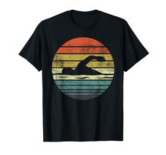 a black t - shirt with an image of a man swimming in the ocean at sunset