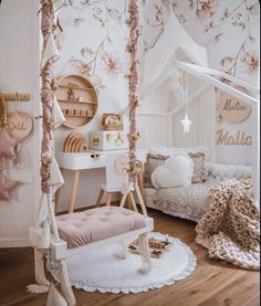 a bedroom with white furniture and pink flowers on the wall, including a canopy bed