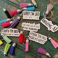 many different colored tassels with words on them