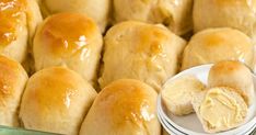 rolls and butter on plates in a display case