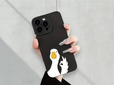 a person holding a phone case with a duck on it