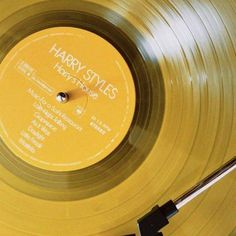 an old yellow record with harry styles on it