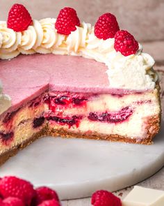 a raspberry cheesecake with one slice cut out