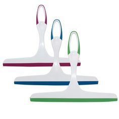 three different colored plastic objects sitting on top of each other in front of a white background