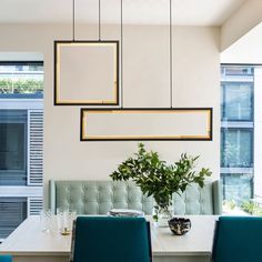 a dining room with blue chairs and a white table