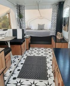 the interior of a camper with black and white tile flooring, wood cabinets and drawers