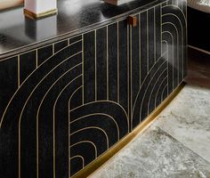 an art deco sideboard in black and gold