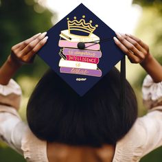 a woman in a graduation cap with her hands on her head