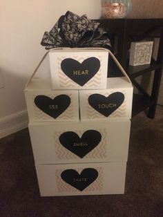 three boxes with hearts on them are stacked up