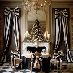 black and white christmas decor in a living room with a fireplace, chandelier and table