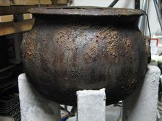 an old pot sitting on top of cement blocks