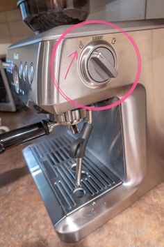 an espresso machine with a red circle in the middle