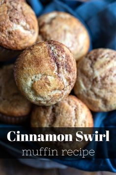 a pile of muffins sitting on top of a blue cloth