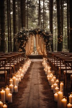 an outdoor wedding ceremony with candles lit up in front of the aisle and flowers on the back