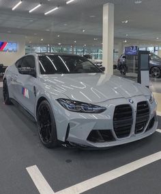 a silver sports car parked in a showroom