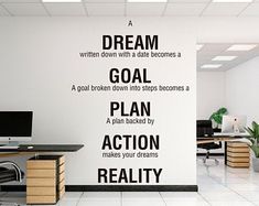 an office with a wall decal that says dream, goal, plan, action, make your dreams