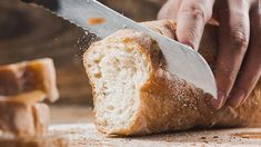 a person cutting bread with a large knife