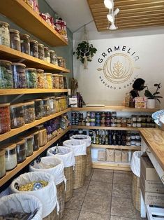 a store filled with lots of different types of food in baskets on the wall and shelves