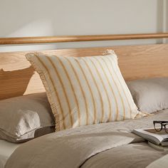 a pair of glasses sitting on top of a bed next to a book and eyeglasses