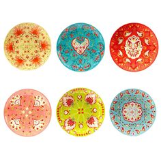 four colorful plates with designs on them are arranged in the same pattern as each other