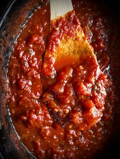 crock pot marinara sauce in a skillet with a wooden spoon on top