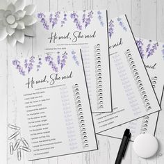 the wedding program is displayed with purple flowers on it, along with other stationery items