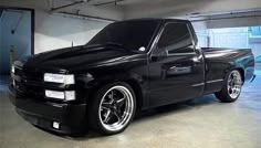 a black truck is parked in a garage