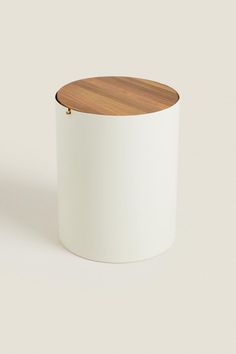 a white container with a wooden lid