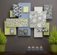 a table with some plants and pictures on the wall in front of it that is decorated with candles