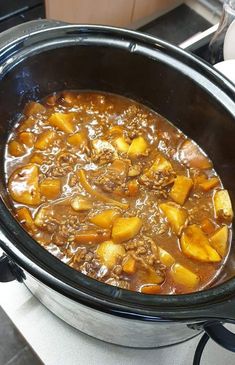 a pot filled with stew sitting on top of a stove