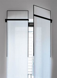 two black and white curtains hanging in front of a window