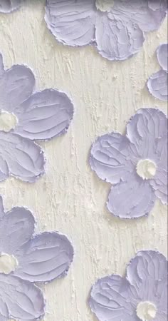 purple flowers are painted on the side of a wall