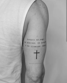 a man with a cross tattoo on his arm