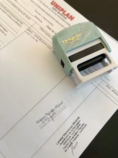 a stamper sitting on top of a piece of paper