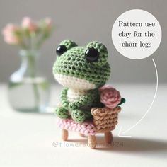 a small crocheted frog holding a flower in it's hand with the caption saying pattern use clay for the chair legs