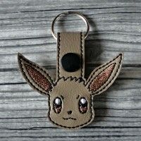 a keychain with a stitched animal on it's front and back ends