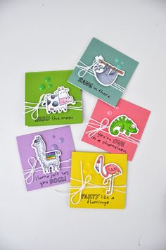 four different colored cards with animals on them