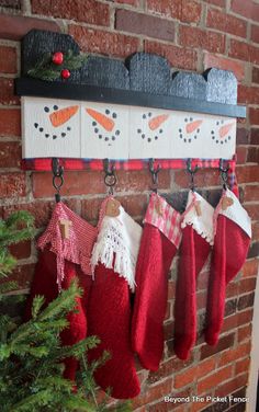 christmas stockings hanging on a brick wall