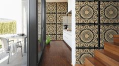 a kitchen and dining room with wallpaper in black and white colors, along with stairs leading up to the upper floor