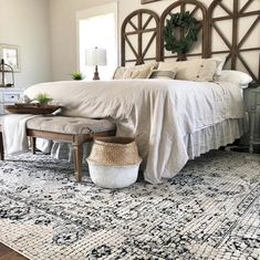 a large bed sitting on top of a wooden floor